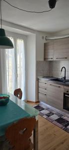 a kitchen with a table and a counter top at Ganesh House in Biasca