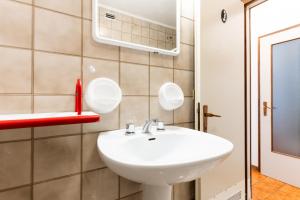a bathroom with a white sink and a mirror at La Zattera in Porto Santa Margherita di Caorle +11 photos