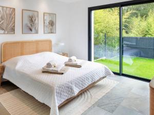 a bedroom with a bed and a large window at Villa de Luxe à Seignosse: Golf, Piscine Chauffée, Proche Plages - FR-1-791-25 in Seignosse