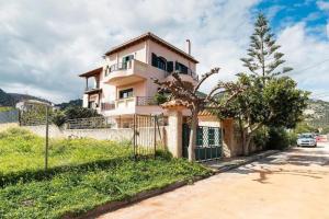a house with a fence in front of it at Anatoli in Nea Makri in Nea Makri