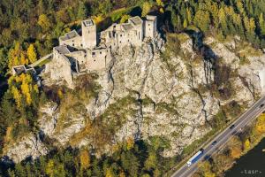 a castle on the side of a mountain with a road at Rekreacny Dom in Strečno
