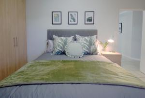 a bedroom with a bed with a pillow on it at Ryneveld Rest in Centurion