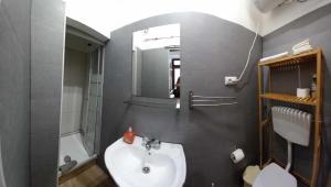 ein Badezimmer mit Waschbecken und Spiegel in der Unterkunft A casinha in Nazaré