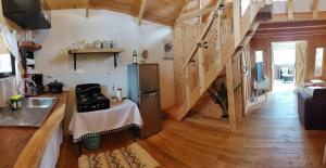 a kitchen with a table and a refrigerator in a room at Cabaña Lugar de paz in Villa Mills