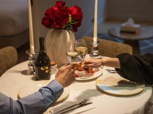 two people sitting at a table with glasses of wine at Quartier Libre Opera in Paris