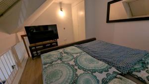 a bedroom with a bed and a flat screen tv at FeWo EssensStube - Gemütlich - Geräumig - Gut in Essen