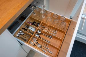 a drawer filled with wine glasses and wine bottles at Boutique Studio Magielsen in Amsterdam