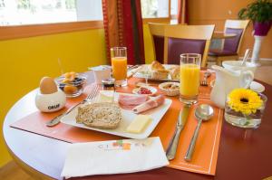 a table with breakfast foods and drinks on it at Cit'Hotel Avantici Gap in Gap