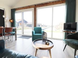 a living room with a couch and chairs and a table at Scenic Stay with Sauna in Anjum