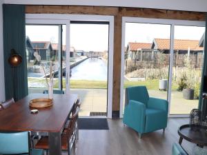 a dining room with a table and chairs and sliding glass doors at Scenic Stay with Sauna in Anjum