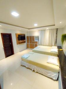 Ένα ή περισσότερα κρεβάτια σε δωμάτιο στο Hotel Jarumã