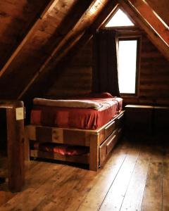 a attic room with a bed and a window at Cabañas Rincon del Ángel 1 in Ciénaga +8 photos