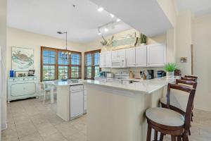 a kitchen with white cabinets and a counter top at 301 West in Gulf Highlands