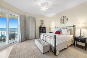 a bedroom with a bed and a view of the ocean at 301 West in Gulf Highlands +34 photos
