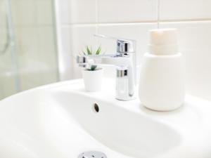 a bathroom sink with a soap dispenser on it at OH KEY Apartments - unlock your stay - Zentral in Fulda-City in Fulda