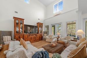 a living room filled with furniture and a flat screen tv at Blue Bayou in Gulf Highlands