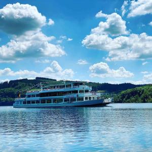a large boat on the water on a lake at #2 Ommi Kese Sansibar Apartment Panorama Balkon in Olpe