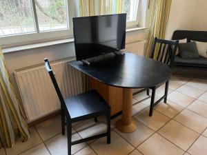 TV a/nebo společenská místnost v ubytování Apartmenthaus Home24