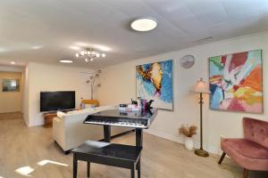 a living room with a piano and a couch at Charming Twin Room & Parking in Saint-Bruno-de-Montarville