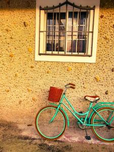 a blue bike parked in front of a window at Private Beachhouse Hacienda Antigua in El Cuyo