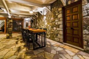 a room with a wooden table and chairs and a door at OpenSea Villa in Thermisía