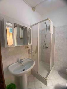 a white bathroom with a shower and a sink at Mar-Mar Panoramica in Riomaggiore +9 photos