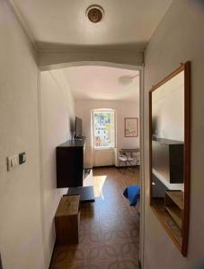 a living room with a mirror and a table at Mar-Mar Panoramica in Riomaggiore