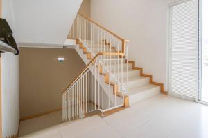 a staircase in a house with a white floor at White Waters Hotel in Machico