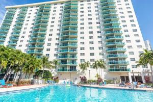 a swimming pool in front of a large building at Ocean Reserve in Sunny Isles Beach