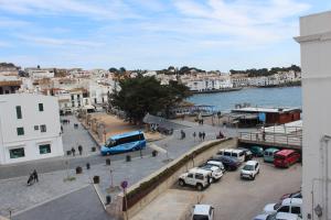 a city with cars parked in a parking lot at Hostal Cristina in Cadaqués