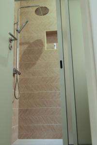 a shower with a glass door in a bathroom at GoBeyond - Lombo T1 in Porto Novo