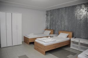una camera con due letti e una parete in bianco e nero di Sobe Sova Kikinda a Kikinda