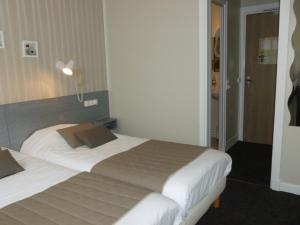 Un ou plusieurs lits dans un hébergement de l'établissement Hôtel LeRichelieu, Le Havre Centre-Ville