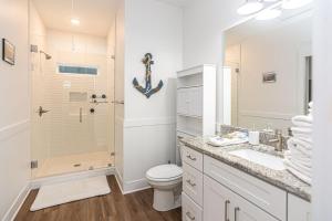 a bathroom with a sink toilet and a shower at 7010 Rookery 3 Sea Shell Cottage New Build in bunks coming soon sleeps 10 in Gulf Shores +20 photos