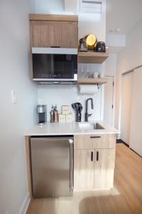a small kitchen with a sink and a microwave at Studio #4 - Self Check-In - Plateau - St-Denis in Montréal