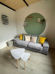 a living room with a couch and a table at Ar Kabanenn, la cabane bretonne cosy in Noyal-Muzillac