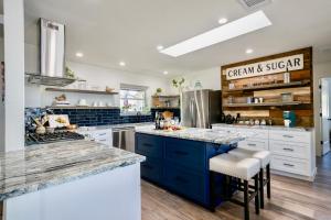 a large kitchen with blue cabinets and white counter tops at Ranchview Retreat in the heart of Johnson City in Johnson City