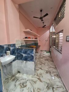 a bathroom with a marble floor and a sink at KumbhaLivingg in Prayagraj
