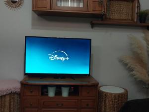 a flat screen tv sitting on top of a wooden cabinet at Casa Carmen in Vélez-Rubio