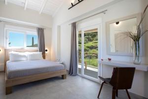 a bedroom with a bed and a window and a chair at Valagron Villa 2 in Nikiana +45 photos