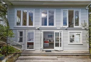a house with large windows and a staircase at Entire Bungalow Lower Level in Auckland