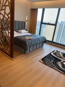 a bedroom with a bed and a large window at Luxurious Suite with Panoramic glass wall in Ghaziabad