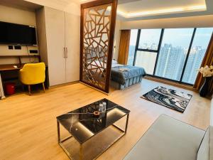 a living room with a large mirror and a table at Luxurious Suite with Panoramic glass wall in Ghaziabad