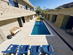 a group of blue lounge chairs and a swimming pool at Villa pio blue in Santa Verónica +11 photos
