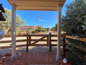 a wooden fence with a view of a road at Kanab Barn Loft House on 40 acres Pet Friendly in Kanab
