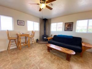 a living room with a blue couch and a table at Kanab Barn Loft House on 40 acres Pet Friendly in Kanab