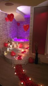 a room with red hearts on the ceiling and lights at Elite Apartment SPA in Catania