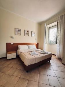 A bed or beds in a room at Hotel Villa Robinia