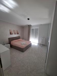a bedroom with a bed in the middle of a room at La casa di Pina in Poggio Imperiale