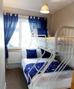 a bedroom with two bunk beds and a window at Kings in Ballyconneely